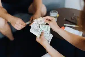 A person handing over a car title loan to another